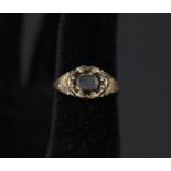 A yellow metal memorial ring with engraved shoulders,