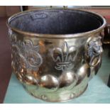 A large 19th Century Dutch embossed brass jardiniere or log bucket with gadrooning and lion mask