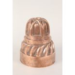 A Victorian circular copper jelly mould of decorative two tier form by Benham & Froud No.