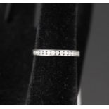 A 9ct white gold channel set diamond ring,