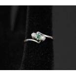An 18ct gold and platinum emerald and diamond three stone ring,