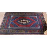 A Persian blue ground geometric rug,