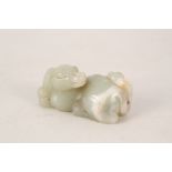 A Chinese Celadon jade carving of a recumbent dog,