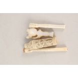 A Chinese ivory cricket case (as found), 2 claw cigarette holders,
