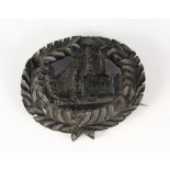 A Victorian bog oak brooch with carved castle scene,