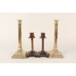 A pair of 19th Century gun meal candlesticks plus a pair of faux tortoiseshell sticks