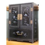 A Chinese black lacquer and mother of pearl table cabinet