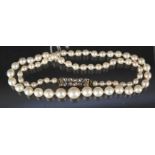 A single strand of culture pearl necklace with yellow metal clasp set with ten old cut diamonds