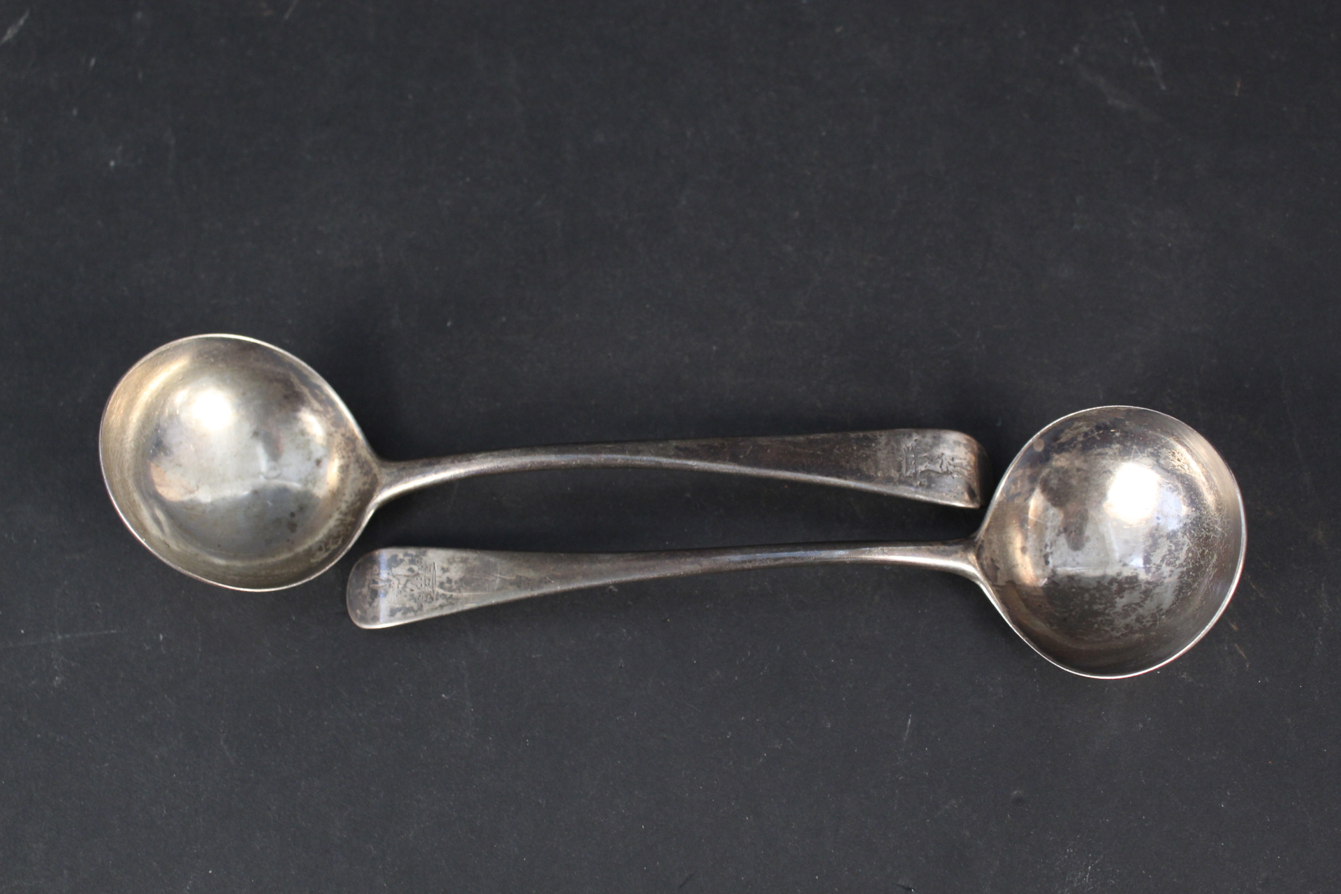 Two Georgian silver ladles bearing crests, hallmarked London 1788 and 1786,