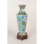 A good quality Chinese cloisonne vase with hexagonal body and flared neck and wooden stand,