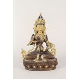 A Tibetan gilt bronze Buddha with painted face and set with turquoise and coral cabochons,