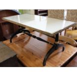 An ebonised and gilt coffee table with brass and glass top