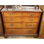 A George III mahogany chest of four long drawers with original metal rope and swag handles and