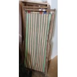 A pair of vintage deckchairs with stripped canvas