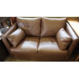 A Multiyork brown leather two seater sofa