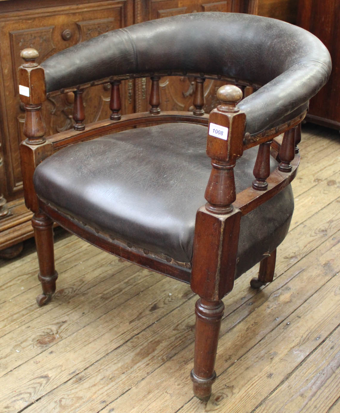 A Victorian mahogany frame and leather upholstered smokers bow chair