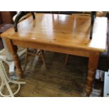 A modern pine dining table with three beech dining chairs