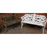 A cast iron white painted garden bench and a weathered wooden garden bench