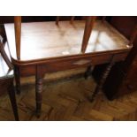 An Edwardian mahogany table with turned legs