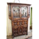 An unusual oak cabinet with fall front top,