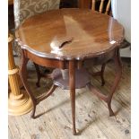 An Edwardian shaped top occasional table with under tier