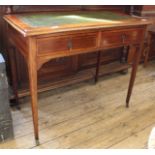 An Edwardian inlaid mahogany writing desk with green leather inset top and two drawers on castors
