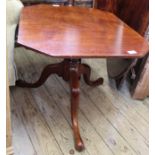 A Victorian shaped top tripod table