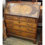 A profusely inlaid early 19th Century four drawer bureau with inlaid decoration to the interior