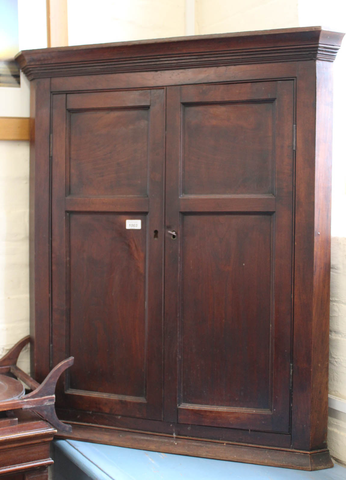 A 19th Century oak and mahogany wall hanging two door corner cupboard