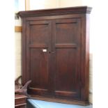 A 19th Century oak and mahogany wall hanging two door corner cupboard