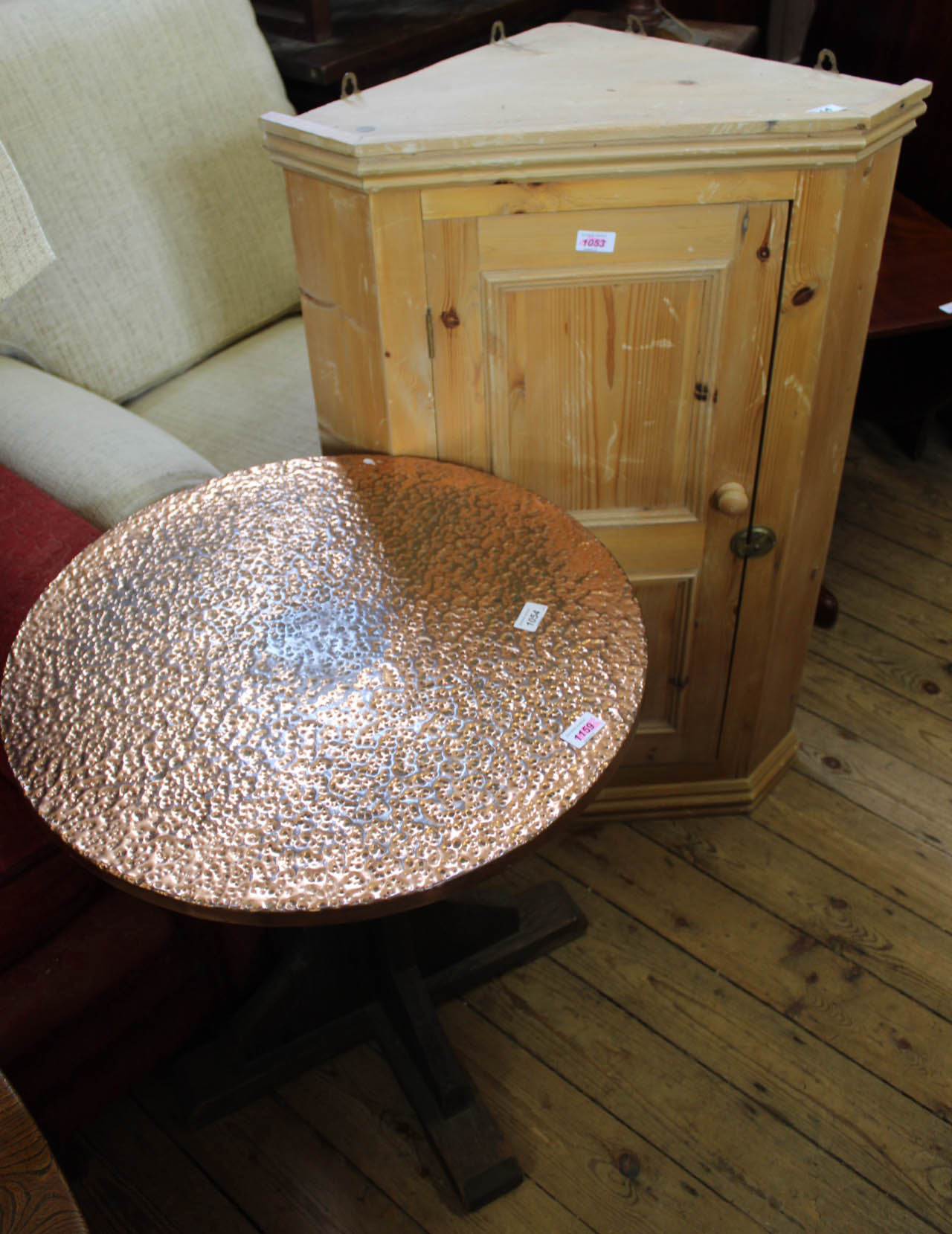 A 1920's oak round table with hammered copper top and a modern pine hanging corner cupboard with