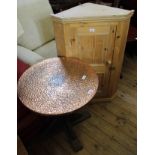 A 1920's oak round table with hammered copper top and a modern pine hanging corner cupboard with