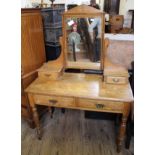 An Edwardian dressing table with two drawers and mirrored upstand