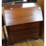 An Edwardian inlaid mahogany three drawer bureau