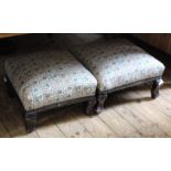 Two Edwardian black lacquered foot stools with matching upholstery