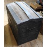A vintage domed top canvas and metal bound trunk