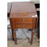 A mahogany double flap two drawer occasional table on turned legs