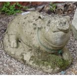 A weathered concrete statue of a pig