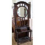 An Edwardian style oak hall stand with circular mirror