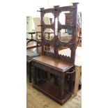 A 1920's carved oak hall stand with part mirrored back and drawers