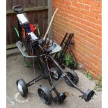 Two golf trolleys, a wheel barrow, a fire grate,