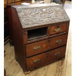 A 19th Century carved oak four drawer bureau of small proportions,