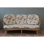 A blonde Ercol kidney shaped three seater sofa