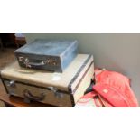 A vintage suitcase containing dressing up clothes and another small suitcase