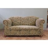 A 1930's two seater sofa with jaunty Moquette upholstery