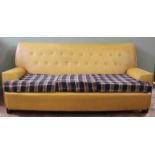 A 1960's mustard vinyl button back sofa with checked seat cushions