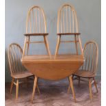A 1970's light Ercol dining table and four hoop back chairs