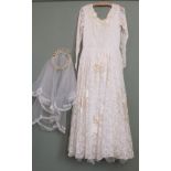 A vintage wedding dress, veil, two pairs of gloves and an Attaboy Trilby,
