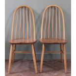 A pair of Ercol ash and elm hoop back chairs