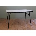 A black and white melamine top and black metal frame table